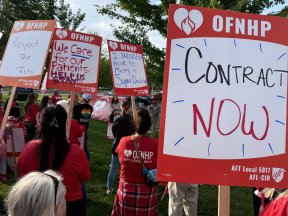 St. Charles picket with many union signs, including one that says Contract Now!