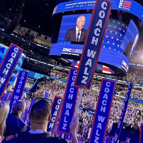 Tim Walz signs at the DNC.