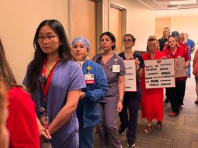 Workers marching on boss to deliver opposition to cuts.
