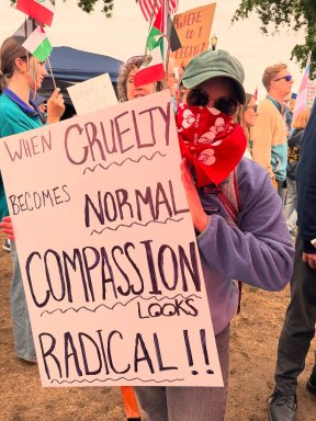OFNHP member protesting at No Kings Day with a sign that says "when cruelty becomes common, compassion becomes radical!