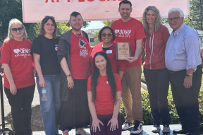Labcorp workers standing alongside Sarina Roher with their AFL-CIO award.