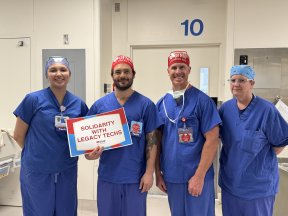 Techs are holding their solidarity sign at LMP!